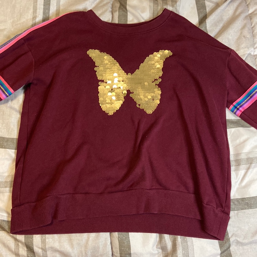 Size: Small. Maroon-ish sweater with gold butterfly sequins and colorful strips.